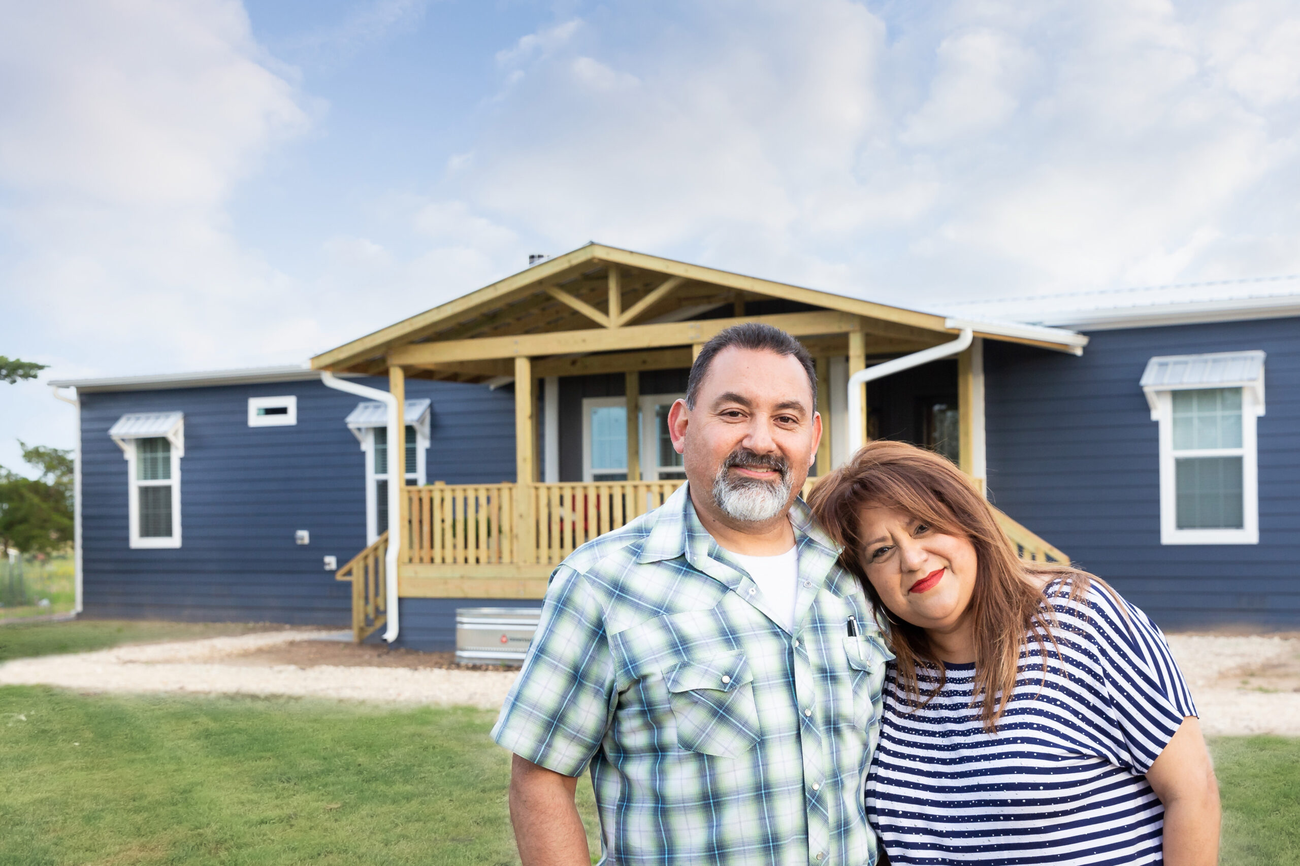 Couple_standing_in_front_of_their_Custom_Clayton_built_home